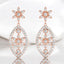 Aretes colgantes con forma de flor y diamantes redondos de 0,52 quilates en oro rosa de 18 quilates