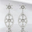 Aretes colgantes con forma de flor y diamantes redondos de 0,52 quilates en oro blanco de 18 quilates