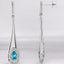 Aretes colgantes con diamantes y topacio azul en forma de pera en oro blanco de 14 kt