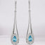 Aretes colgantes con diamantes y topacio azul en forma de pera en oro blanco de 14 kt